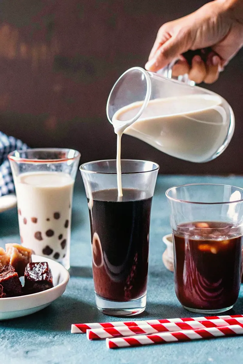 Bubble Milk Tea Calories shown through three different drinks, including one with tapioca pearls and another being mixed with milk