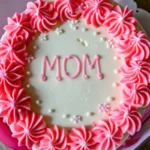Pink and white bento cakes with frosting that says "Mom" for Mother's Day