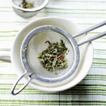 Loose-leaf green tea in strainer for coconut milk green tea recipe