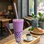 Taro milk tea in a tall glass with tapioca pearls