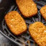 crispy golden hash brown patties in air fryer basket