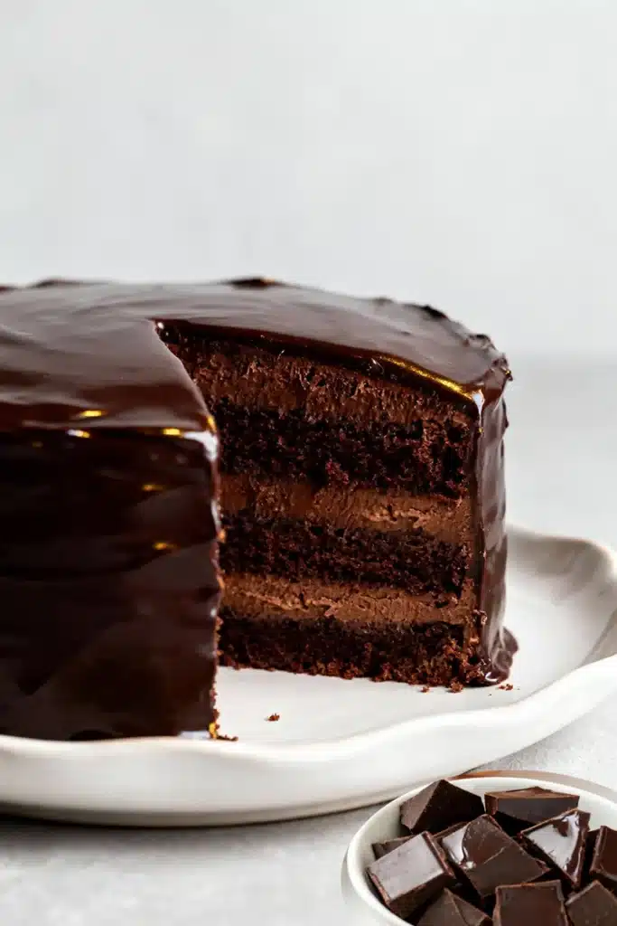 Sugar-free chocolate truffle cake with glossy ganache and rich layers on a plate